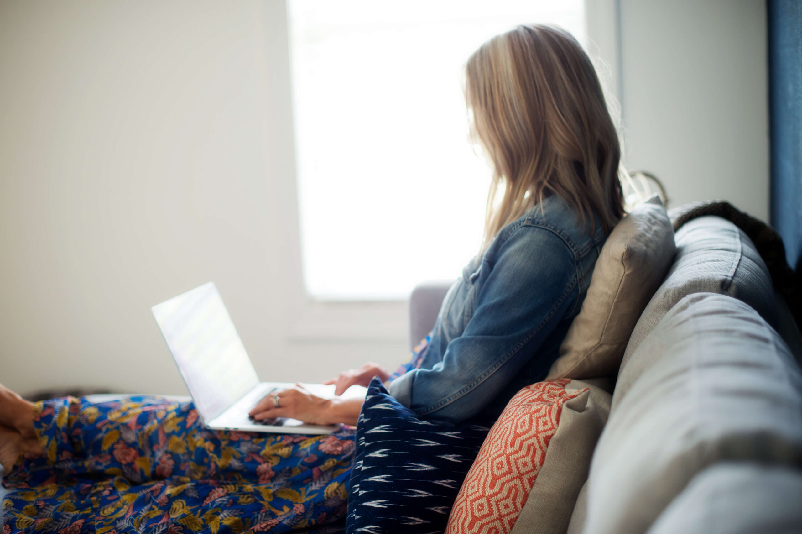 Angie Mizzell writing her weekly newsletter Hello. Friday